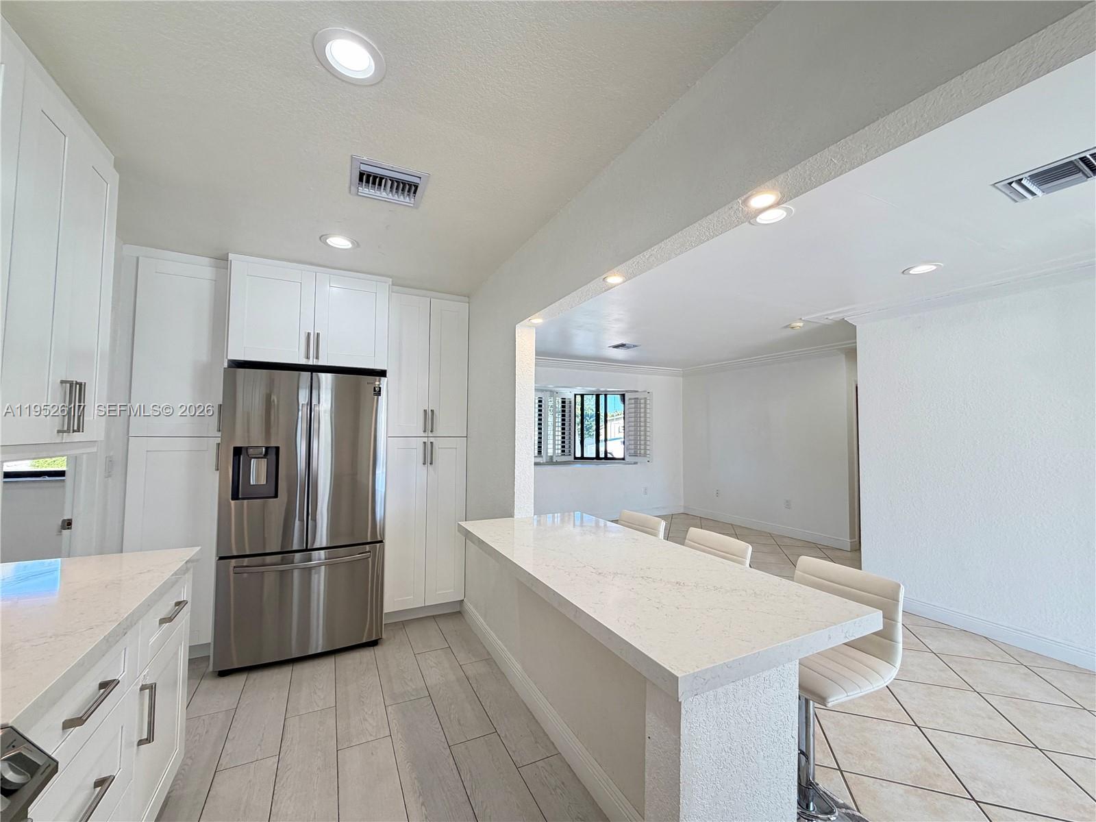 16320 Southwest 278th Street Homestead, FL 33031 - Photo 16 of 69 a kitchen with refrigerator cabinets and wooden floor