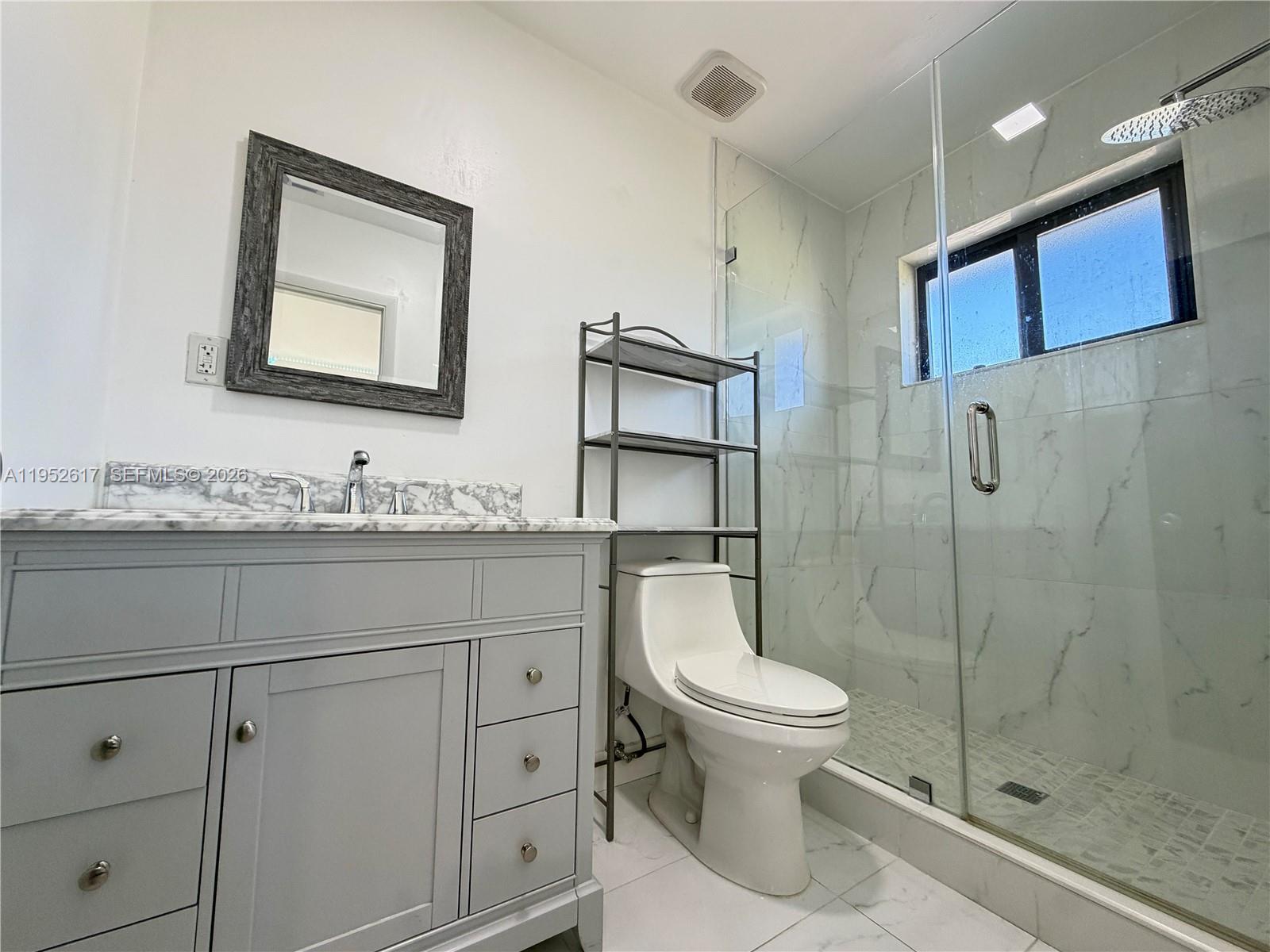 16320 Southwest 278th Street Homestead, FL 33031 - Photo 29 of 69 a bathroom with a granite countertop toilet sink and mirror