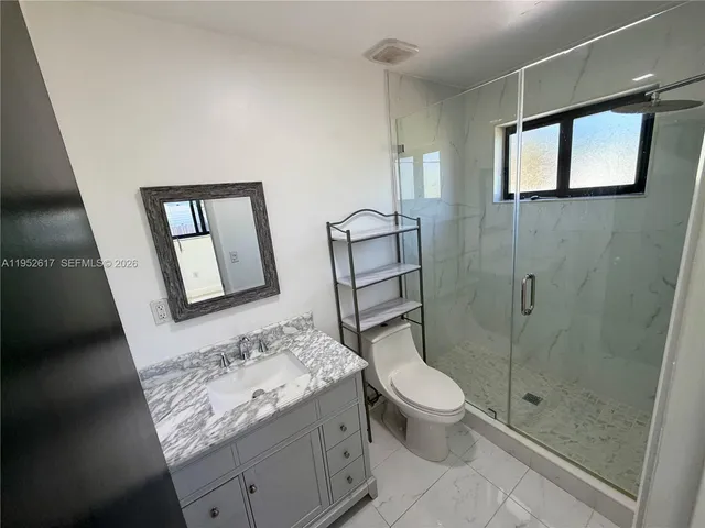 a bathroom with a shower and a sink