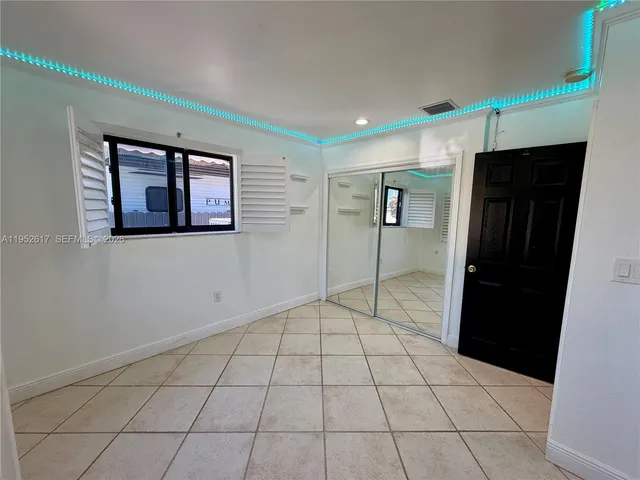 a spacious bathroom with a granite countertop sink and a large mirror