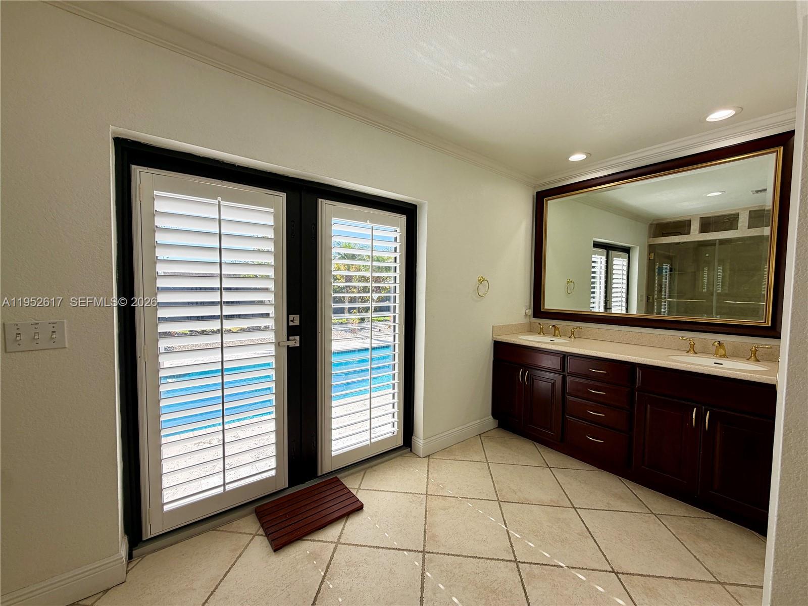 16320 Southwest 278th Street Homestead, FL 33031 - Photo 39 of 69 a spacious bathroom with a granite countertop sink and a large mirror