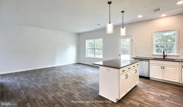 a kitchen with granite countertop a sink and window