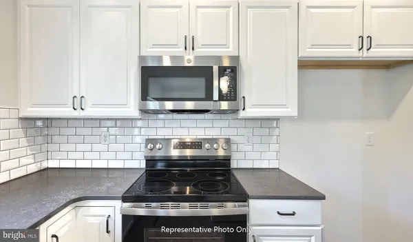 a kitchen with a stove and a microwave