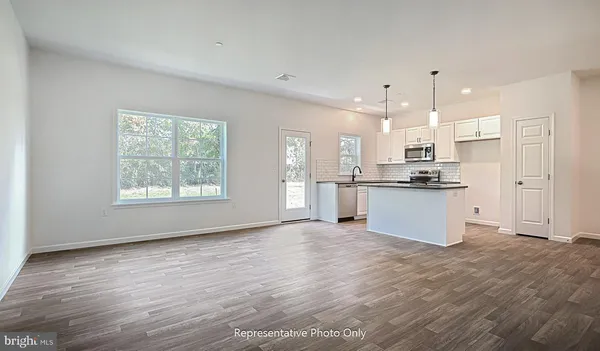 a view of kitchen with wooden floor and window