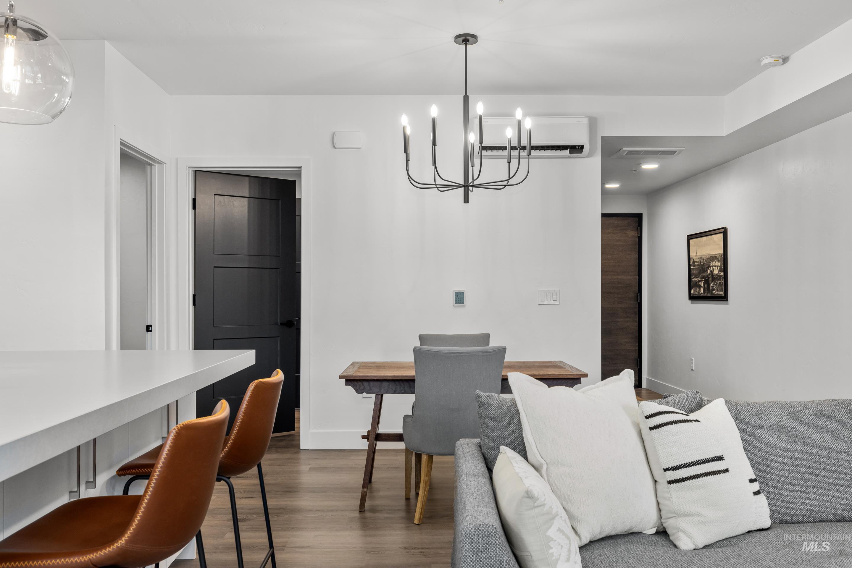 1620 West Bannock Street, Unit 403 Boise, ID 83702 - Photo 12 of 38 Dining space with dark wood-style flooring, a chandelier, an AC wall unit, and recessed lighting