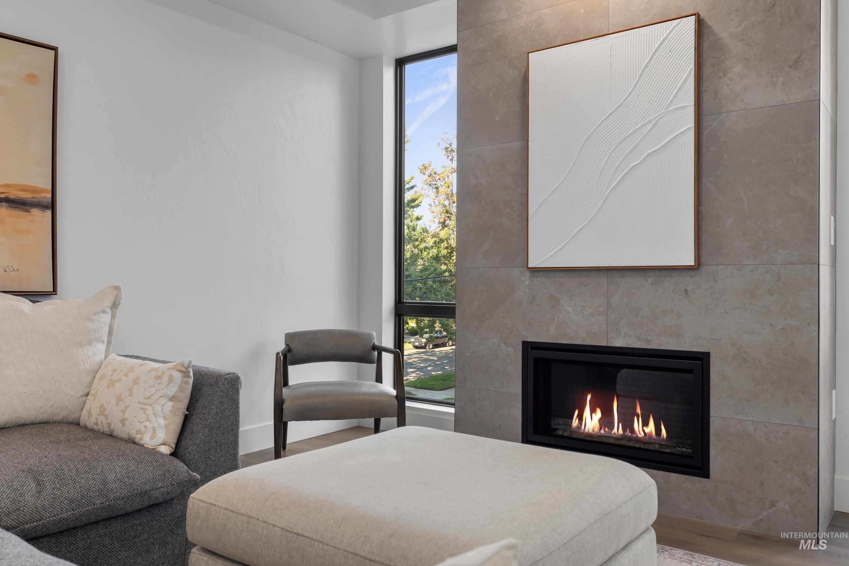 1620 West Bannock Street, Unit 403 Boise, ID 83702 - Photo 9 of 38 Living area featuring wood finished floors, a fireplace, and floor to ceiling windows