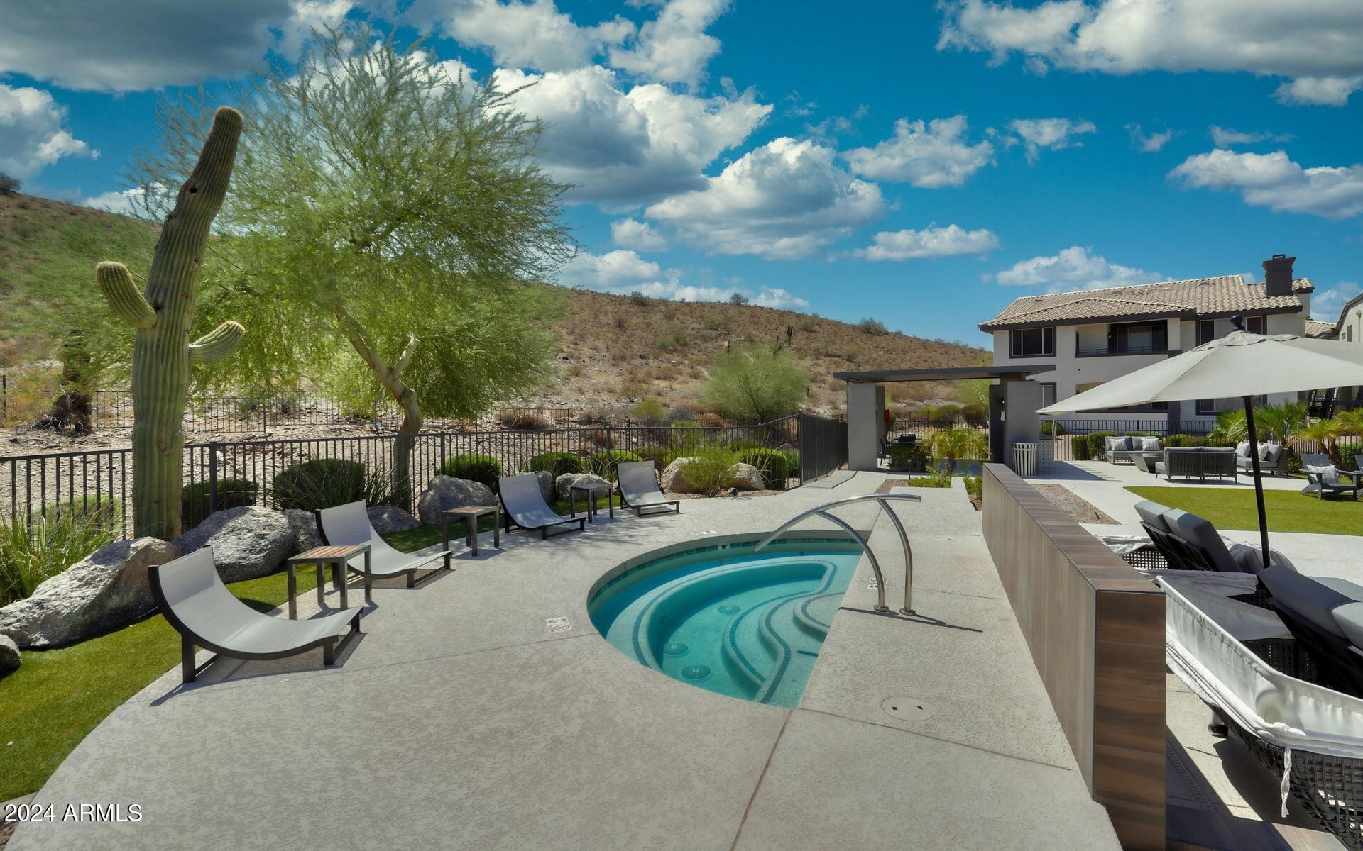 3625 East Ray Road, Unit 1 Phoenix, AZ 85044 - Photo 24 of 29 a view of a swimming pool and lounge chairs