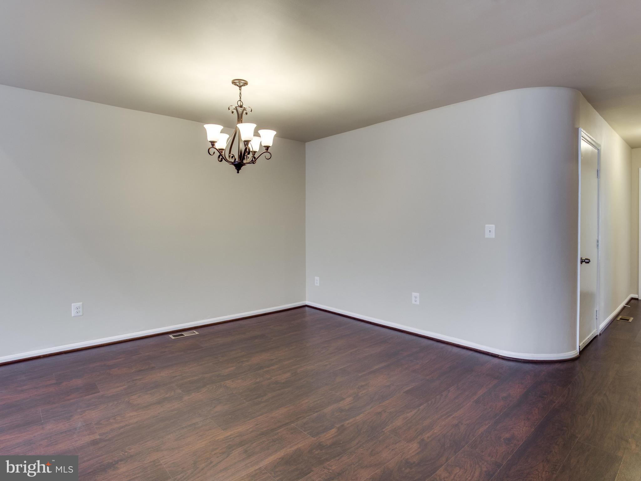 9320 Ispahan Loop Laurel, MD 20708 - Photo 12 of 30 wooden floor in an empty room with a window