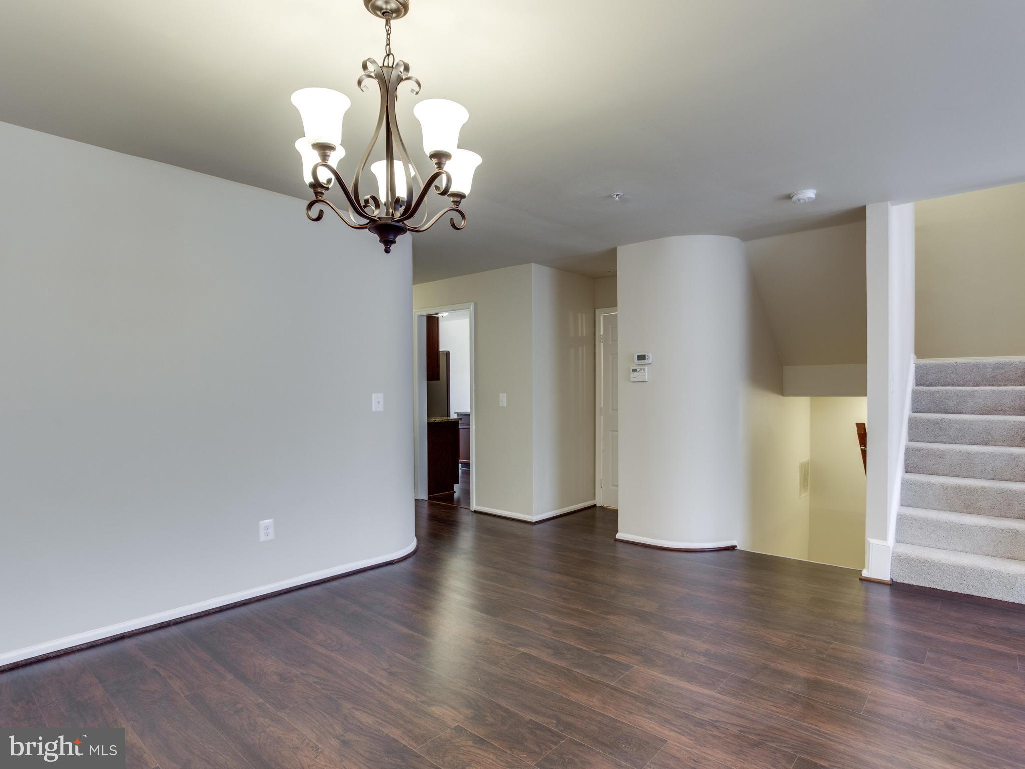9320 Ispahan Loop Laurel, MD 20708 - Photo 13 of 30 a view of a hallway with wooden floor