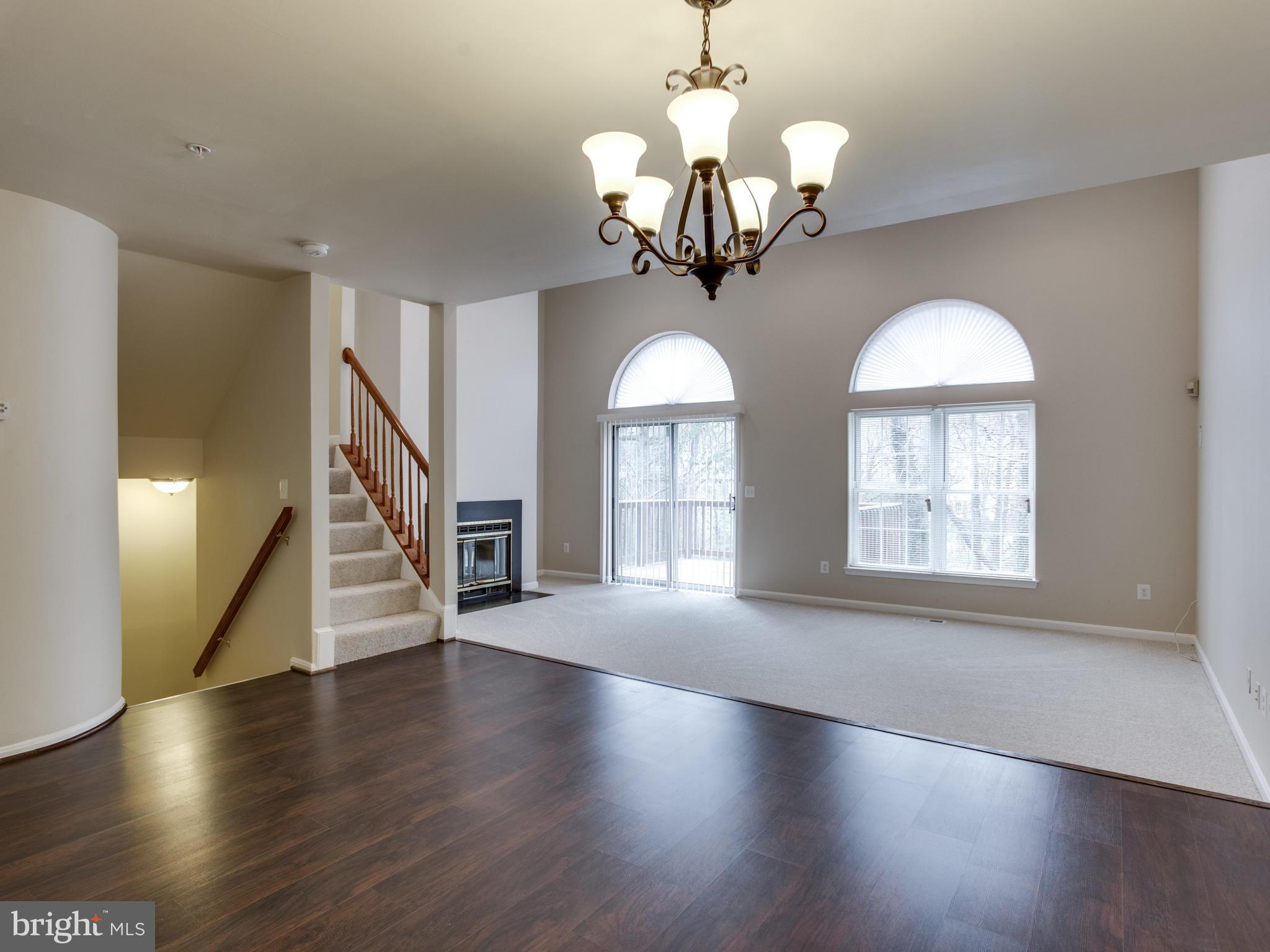 9320 Ispahan Loop Laurel, MD 20708 - Photo 14 of 30 a view of a room with wooden floors and chandelier