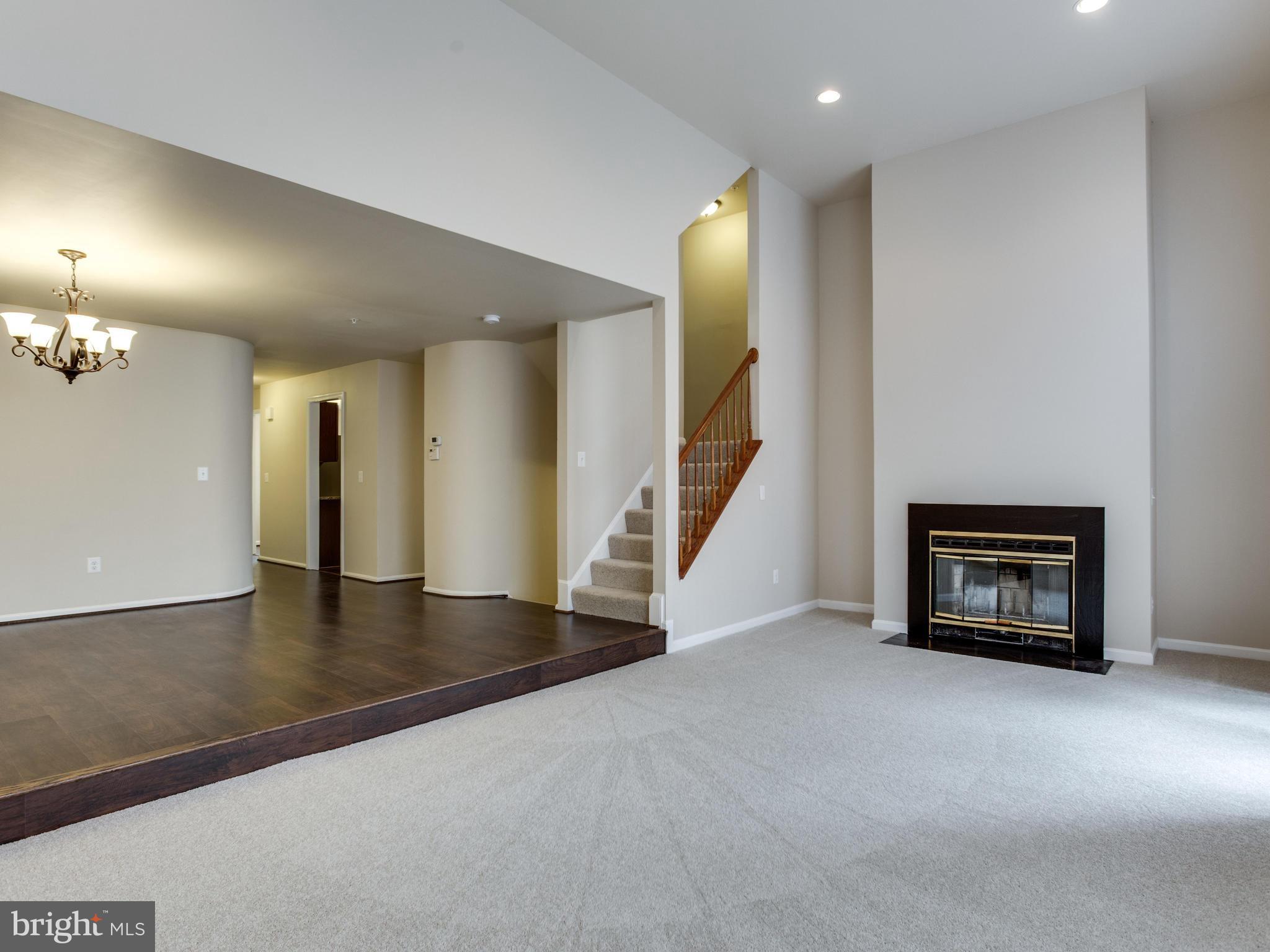 9320 Ispahan Loop Laurel, MD 20708 - Photo 16 of 30 an empty room with windows and fireplace