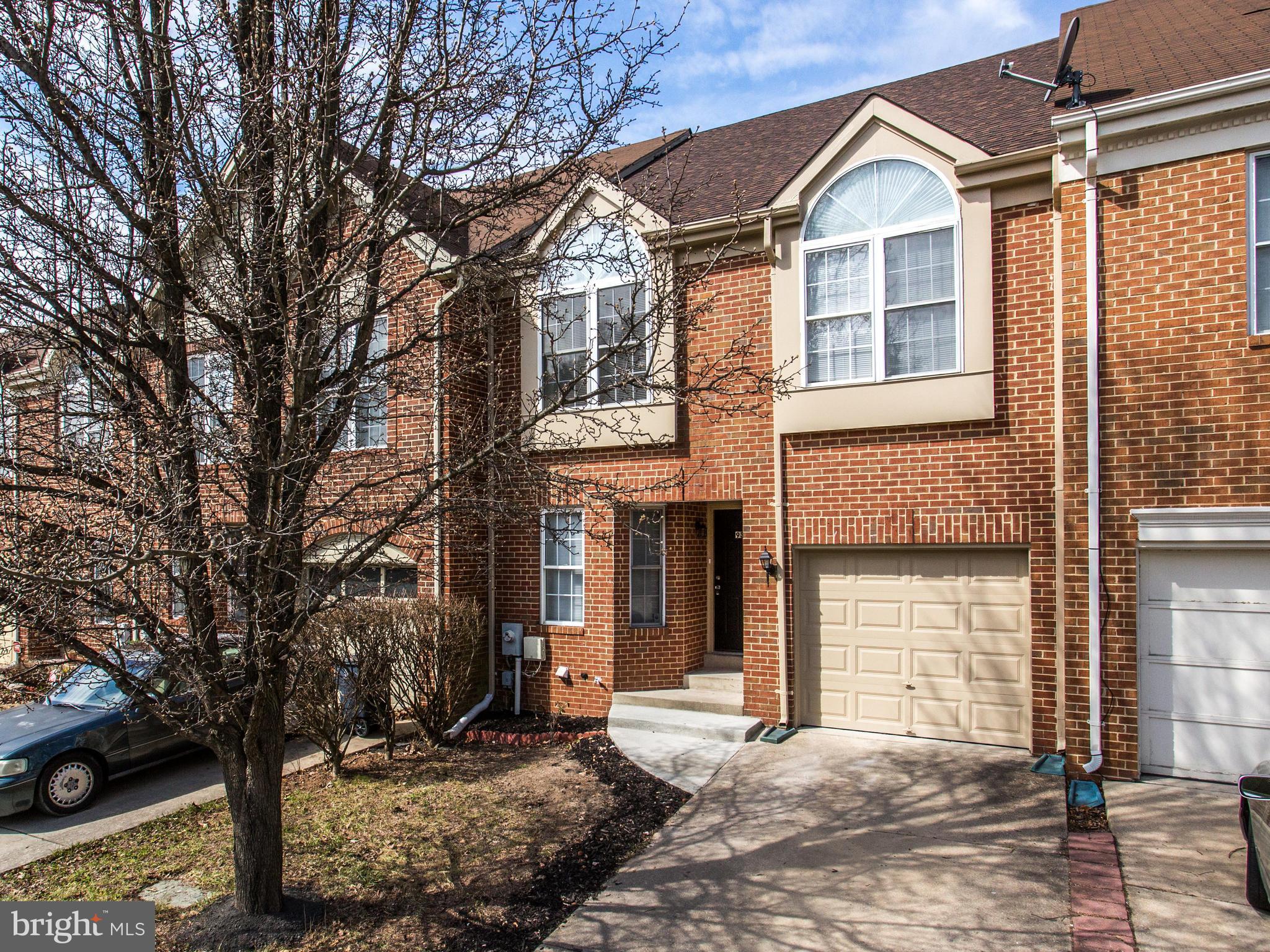 9320 Ispahan Loop Laurel, MD 20708 - Photo 3 of 30 a view of a brick house with large windows and large tree