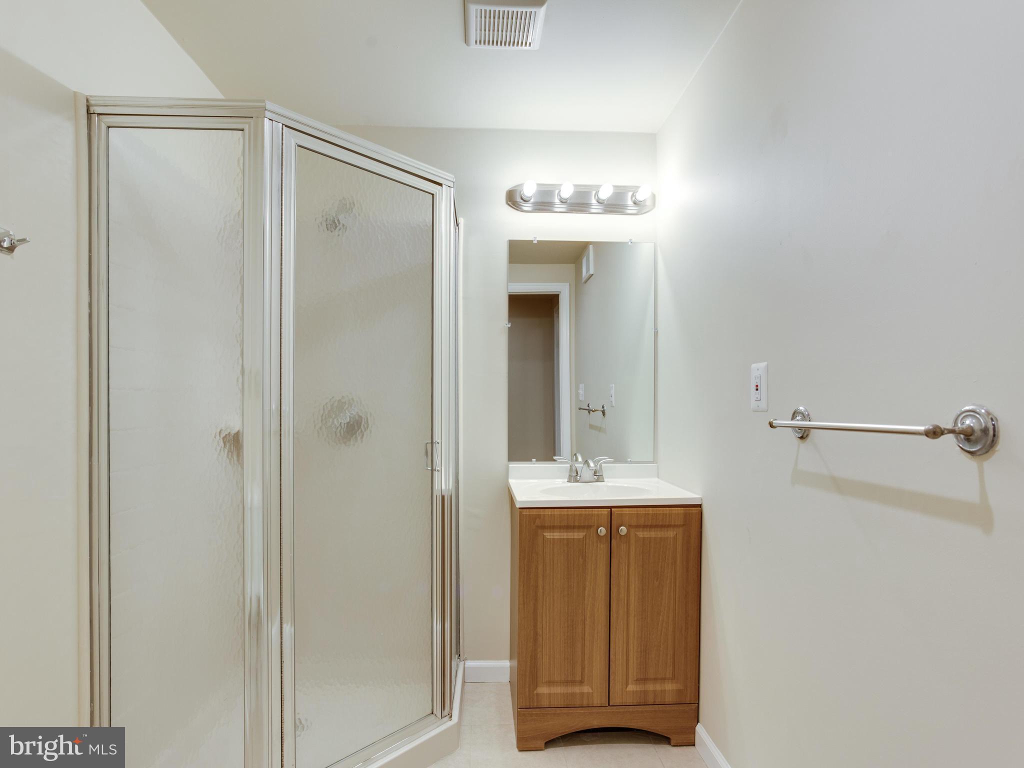 9320 Ispahan Loop Laurel, MD 20708 - Photo 30 of 30 a view of a bathroom with a sink and mirror
