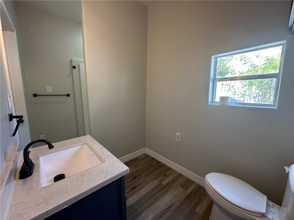 221 Commerce Street, Unit E Portland, TX 78374 - Photo 22 of 26 a bathroom with a sink toilet and vanity