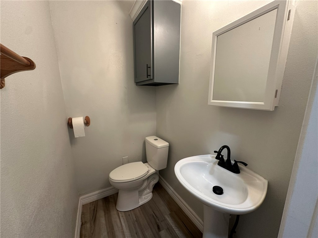 221 Commerce Street, Unit E Portland, TX 78374 - Photo 23 of 26 a bathroom with a sink and a toilet