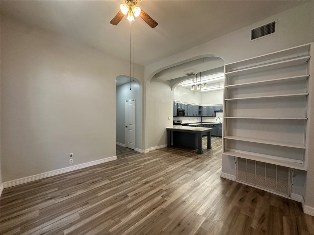 221 Commerce Street, Unit E Portland, TX 78374 - Photo 4 of 26 a view of a room with kitchen appliances and wooden floor