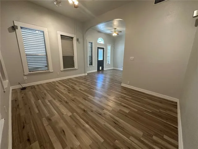 wooden floor in an empty room with a mirror