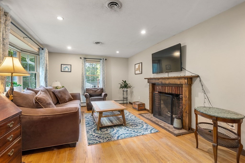 73 Northridge Road Westfield, MA 01085 - Photo 4 of 21 a living room with furniture a flat screen tv and a fireplace