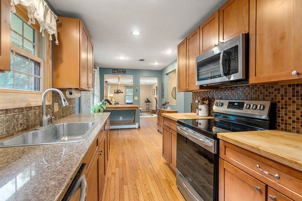 73 Northridge Road Westfield, MA 01085 - Photo 6 of 21 a kitchen with stainless steel appliances granite countertop a stove a sink and a microwave