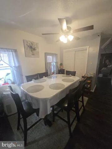 a view of a dining room with furniture and a chandelier