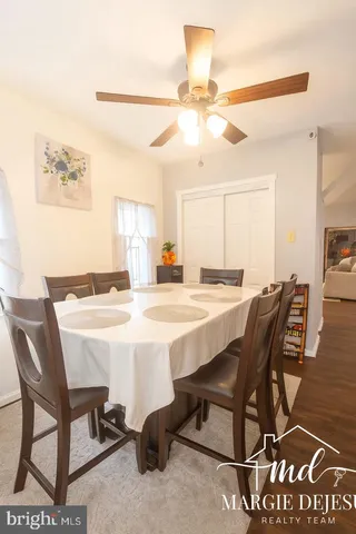a dining room with a wooden table and chairs