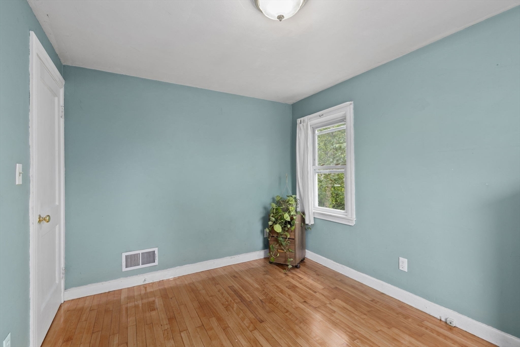 77 Olson Street Abington, MA 02351 - Photo 15 of 27 a view of an empty room with wooden floor and a window
