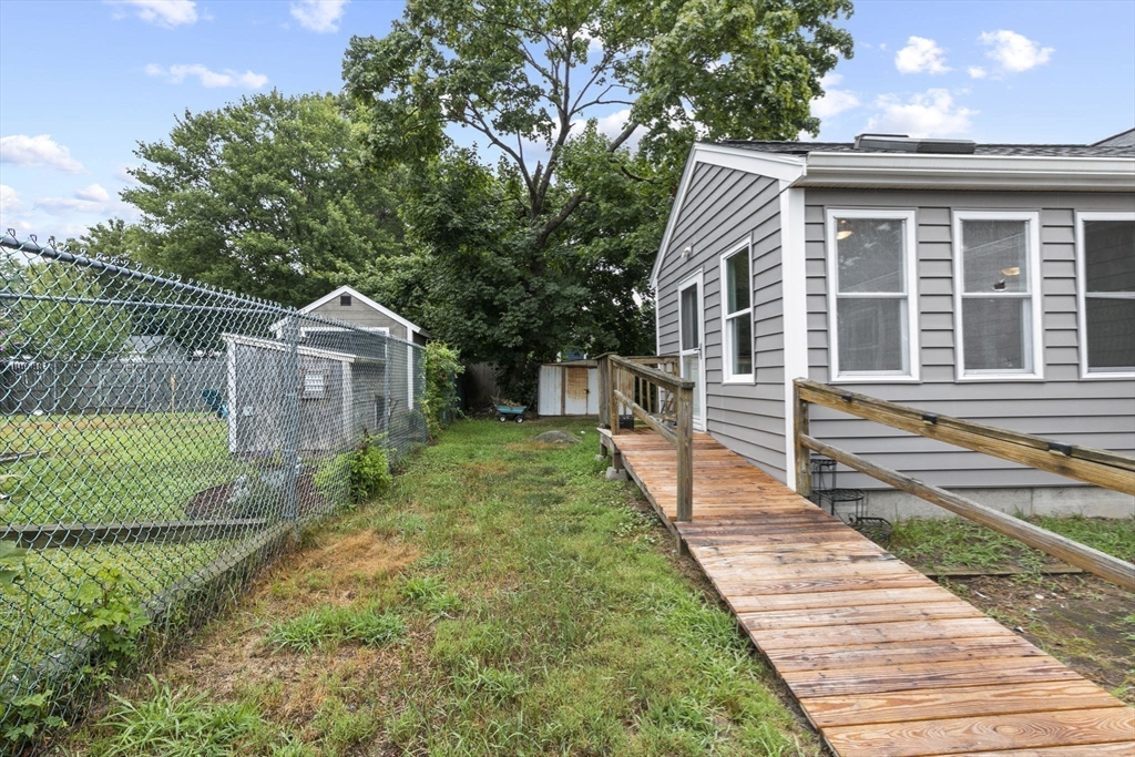 77 Olson Street Abington, MA 02351 - Photo 23 of 27 a front view of a house with a yard and potted plants
