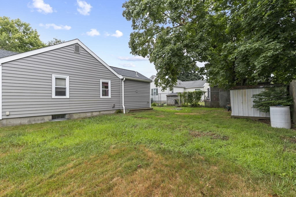 77 Olson Street Abington, MA 02351 - Photo 25 of 27 a front view of house with yard and green space