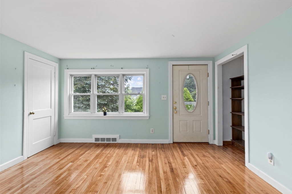 77 Olson Street Abington, MA 02351 - Photo 5 of 27 an empty room with wooden floor and windows