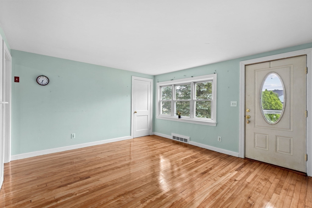 77 Olson Street Abington, MA 02351 - Photo 6 of 27 an empty room with window and wooden floor