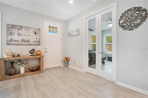 a spacious bathroom with a granite countertop sink a large mirror a shower and vanity