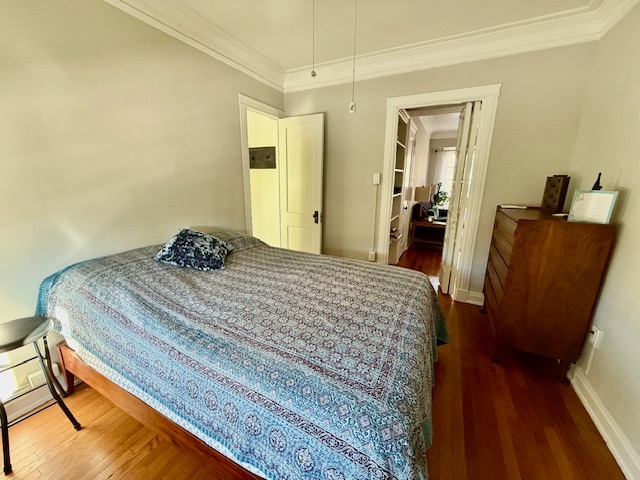 307 North Prairie Street, Unit 9 Champaign, IL 61820 - Photo 14 of 41 a bedroom with a bed and wooden floor