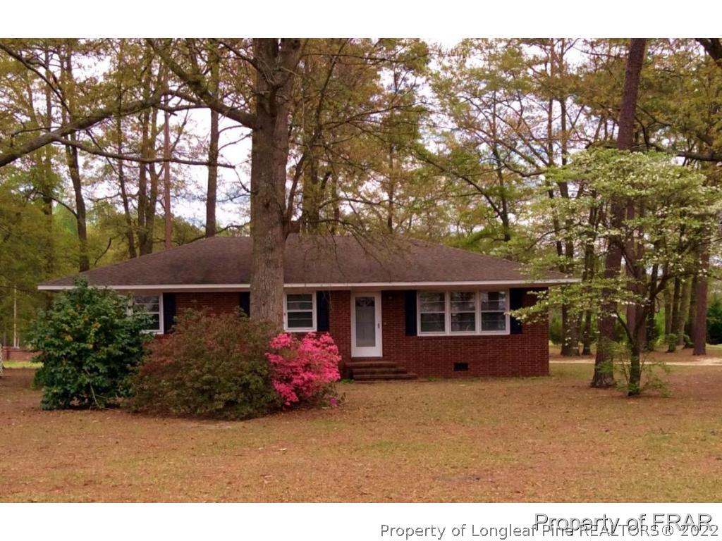 298 Magnolia Church Road Stedman, NC 28391 - Photo 1 of 33 a front view of a house with a garden