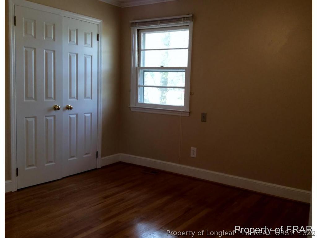 298 Magnolia Church Road Stedman, NC 28391 - Photo 13 of 33 an empty room with wooden floor and windows