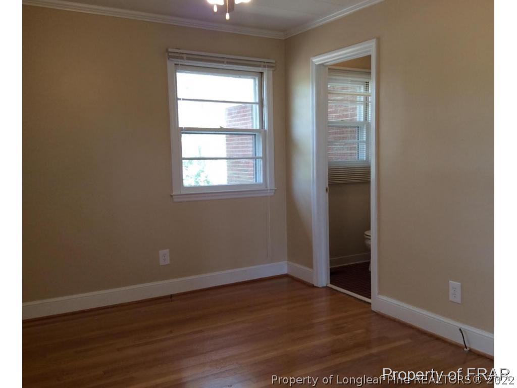 298 Magnolia Church Road Stedman, NC 28391 - Photo 14 of 33 an empty room with wooden floor closet and windows