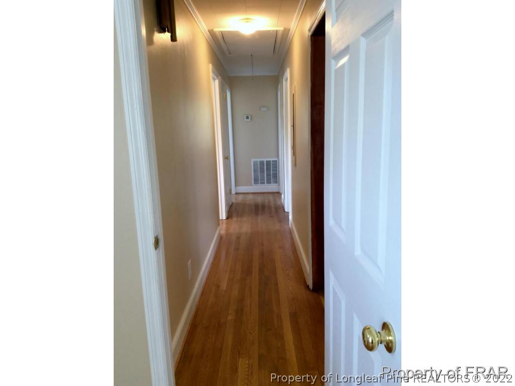 298 Magnolia Church Road Stedman, NC 28391 - Photo 16 of 33 a view of a hallway with wooden floor