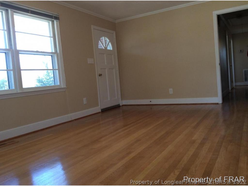298 Magnolia Church Road Stedman, NC 28391 - Photo 5 of 33 an empty room with wooden floor and windows
