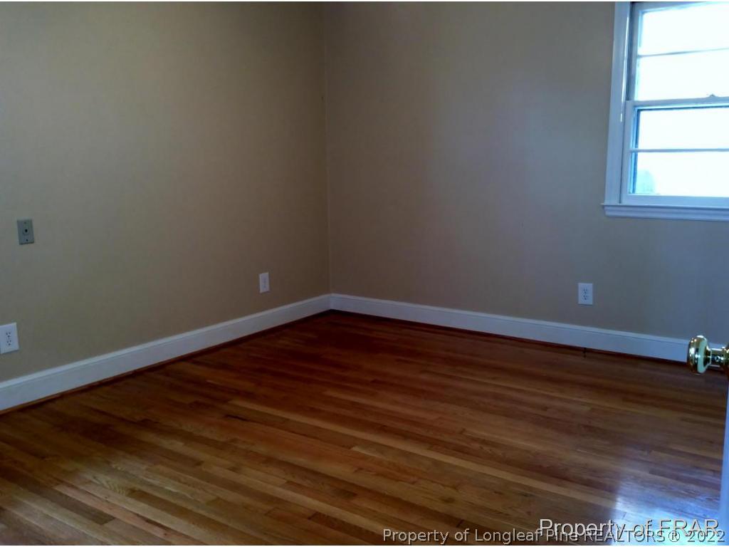 298 Magnolia Church Road Stedman, NC 28391 - Photo 7 of 33 a view of an empty room with wooden floor and a window