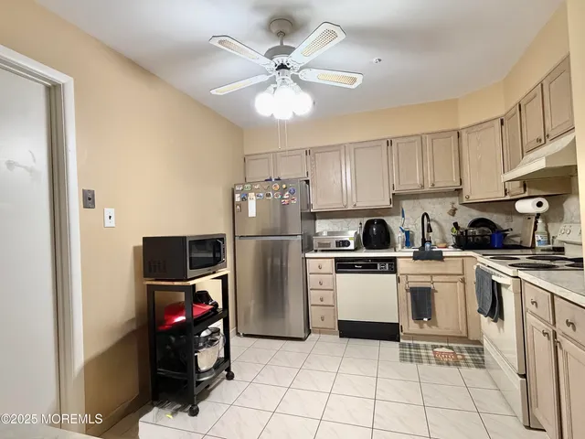 a kitchen with a cabinets a sink and stainless steel appliances