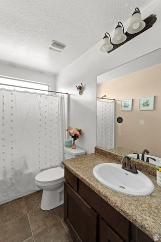 3396 Carmy Road Magna, UT 84044 - Photo 12 of 32 Bathroom featuring a vanity with a laminate countertop, an undermount sink, and a dark wood-finish cabinet