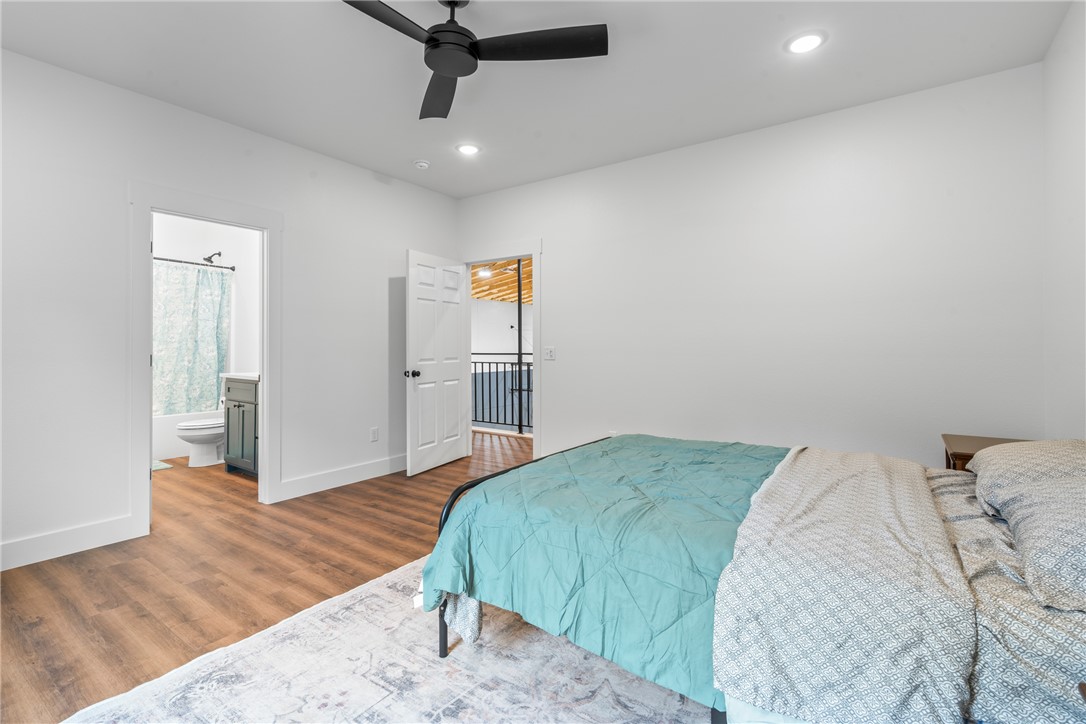 16556 East Hewitt Springs Road Springdale, AR 72764 - Photo 48 of 60 Spacious room featuring wood-finish flooring, a contemporary black ceiling fan, and recessed lighting