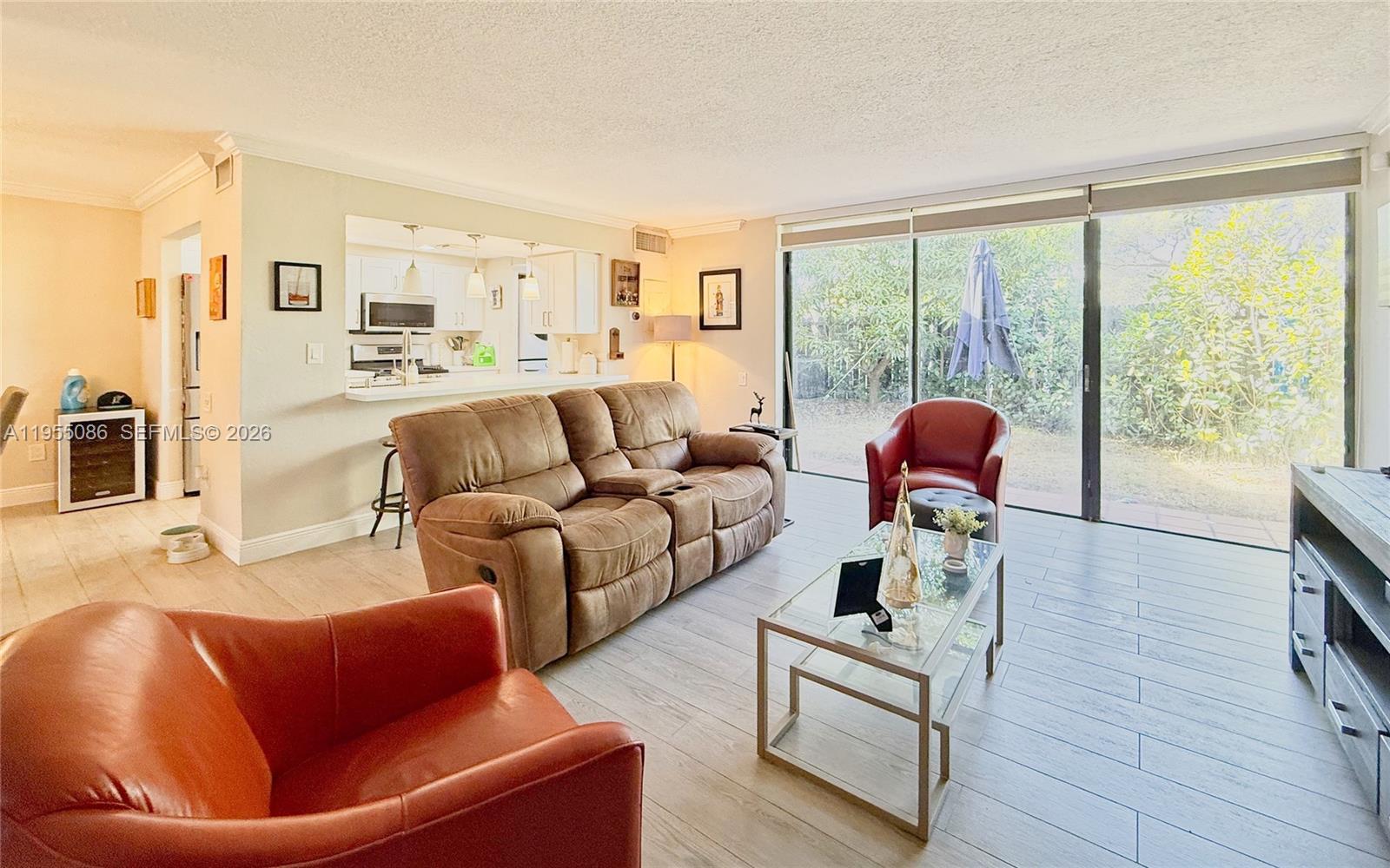 7034 Southwest 112th Court Miami, FL 33173 - Photo 13 of 39 a living room with furniture and a large window