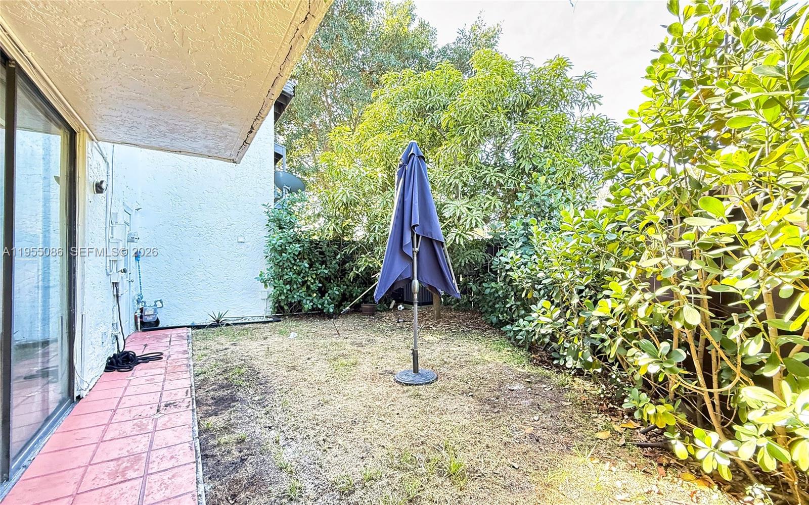 7034 Southwest 112th Court Miami, FL 33173 - Photo 18 of 39 a view of a backyard with brick wall