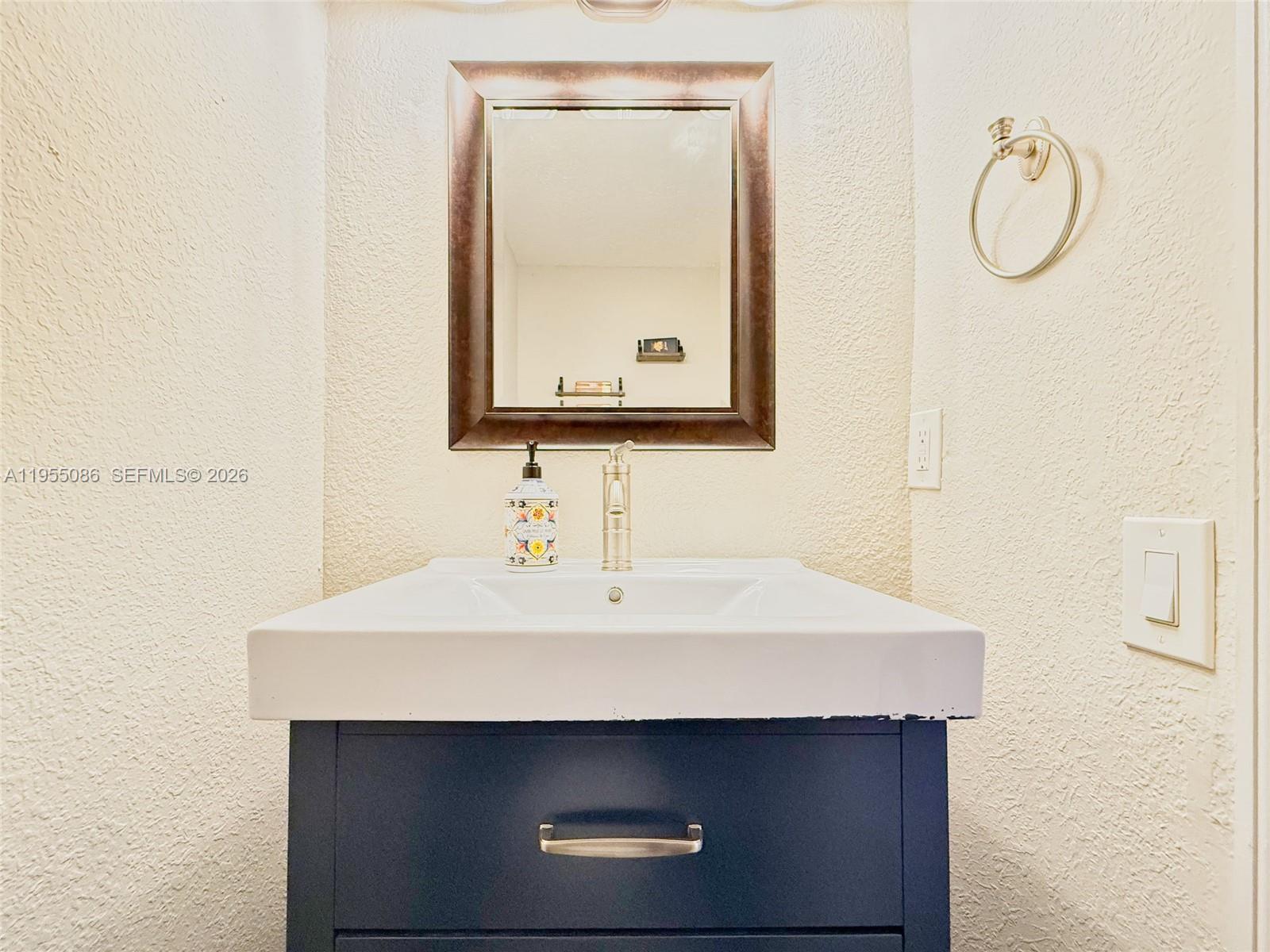 7034 Southwest 112th Court Miami, FL 33173 - Photo 24 of 39 a bathroom with a sink and a mirror