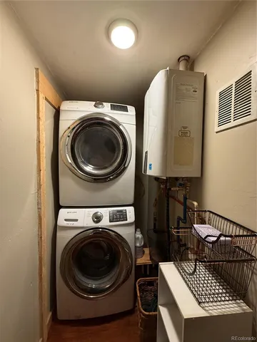 a utility room with dryer washer and a view of bedroom