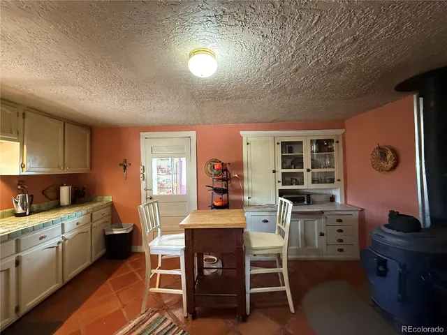 a kitchen with a table chairs and a refrigerator