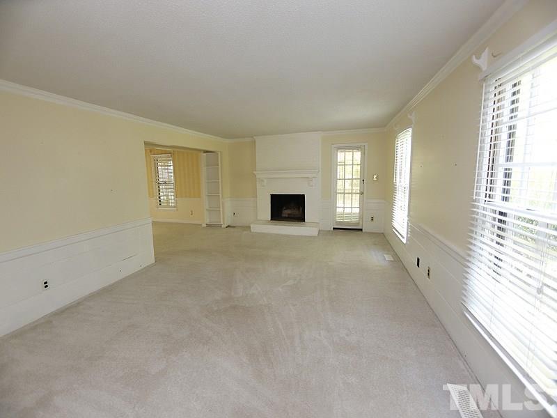 312 Baytree Lane Raleigh, NC 27615 - Photo 2 of 12 a view of a livingroom with wooden floor and a fireplace
