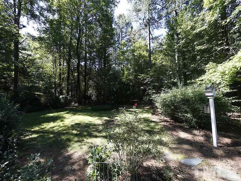 312 Baytree Lane Raleigh, NC 27615 - Photo 11 of 12 a backyard of a house with lots of green space