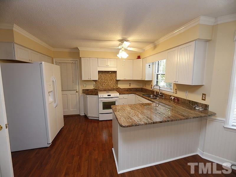 312 Baytree Lane Raleigh, NC 27615 - Photo 5 of 12 a kitchen with granite countertop a sink stove and refrigerator
