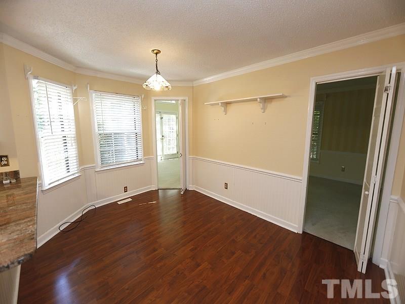 312 Baytree Lane Raleigh, NC 27615 - Photo 6 of 12 an empty room with wooden floor and windows